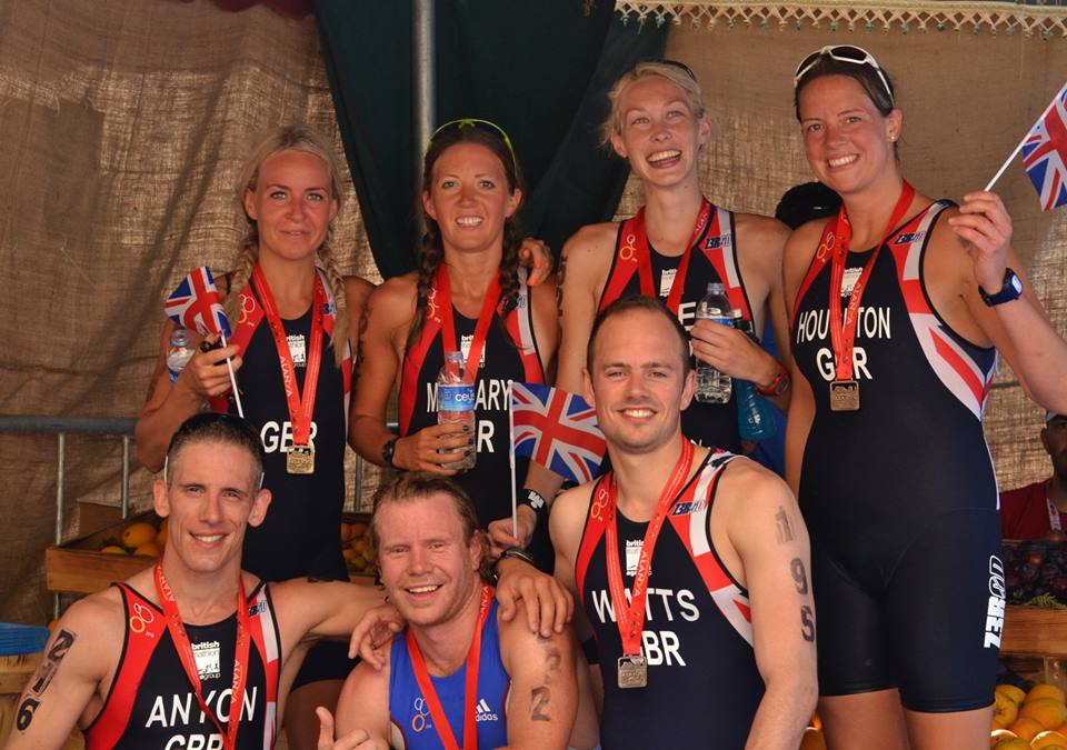 Athletes celebrating in Great Britain kit with medals and Union flags