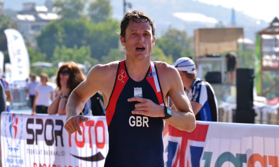 An athlete racing in Great Britain triathlon kit