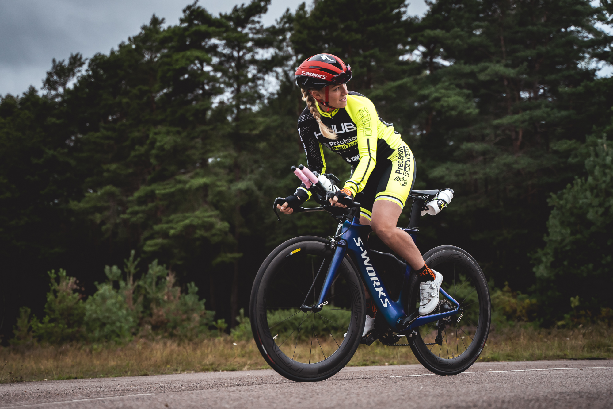 Cyclist riding a road bike through woodland