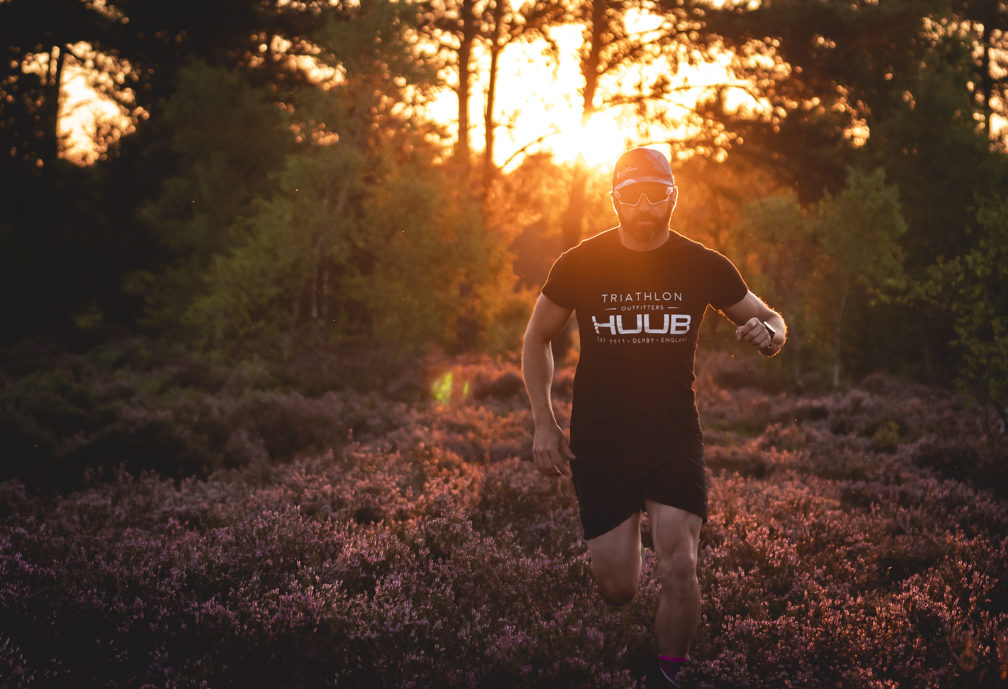 Athlete running across heathland at sunset