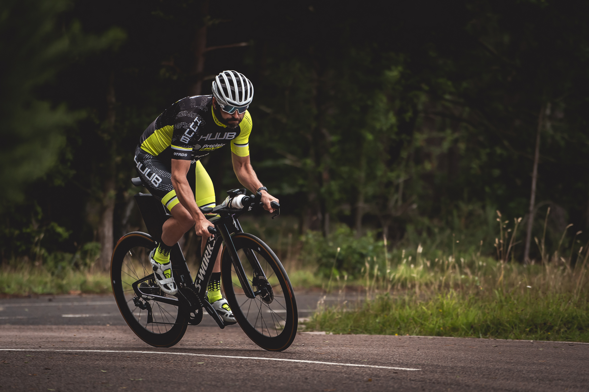 Cyclist training on a quiet tree-lined road